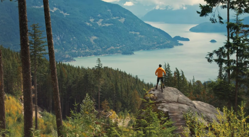 Mountain Bikes. A Cyclist Looking off towards a mountaineous landscape