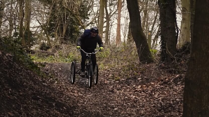 Person Driving a Tricycle Through the Woods