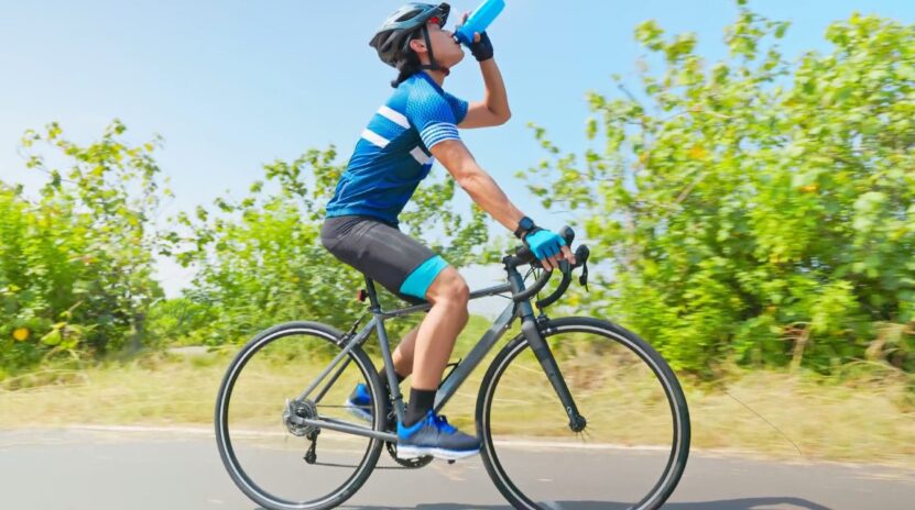 Bike driver take water to fresh him up on sunny weather